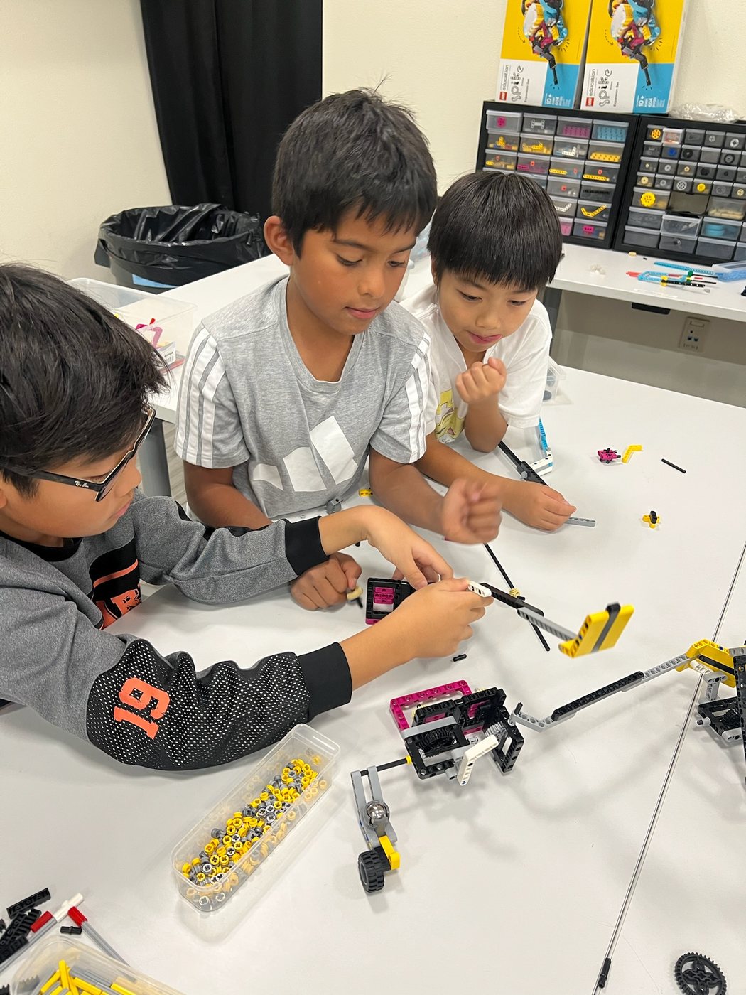 Students building LEGO robotics models during a Reno Rovers practice session
