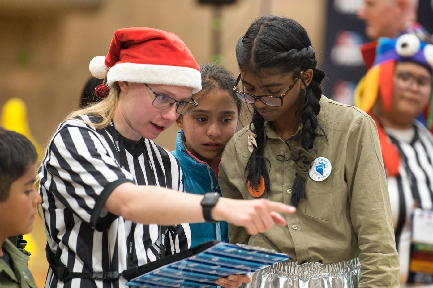 Reno Rovers students talking with a reviewer at a FIRST LEGO League robot game table