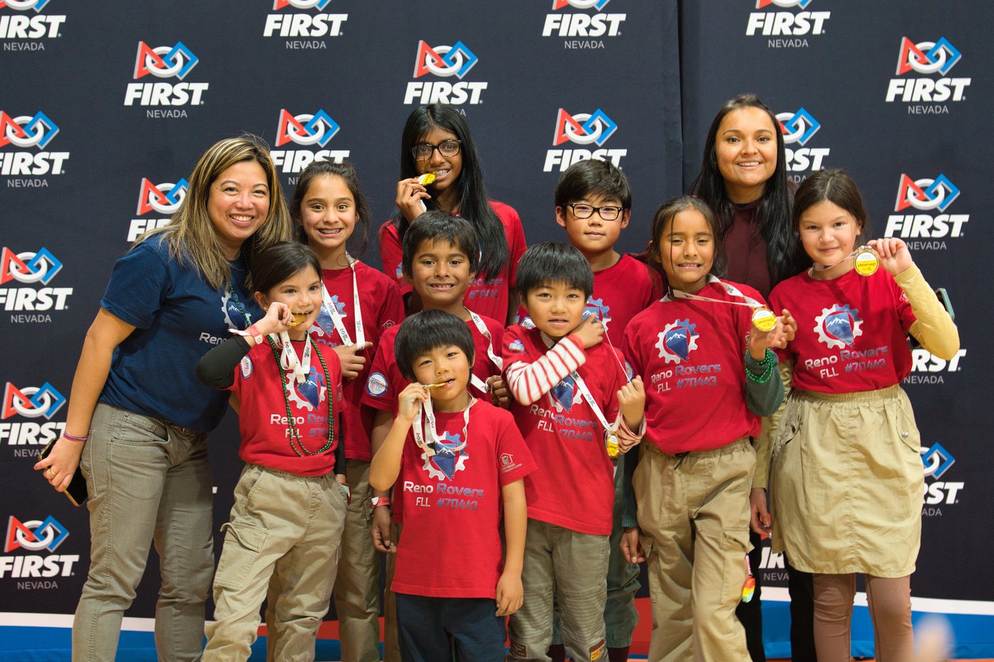 Reno Rovers students in red shirts celebrating awards at a FIRST event